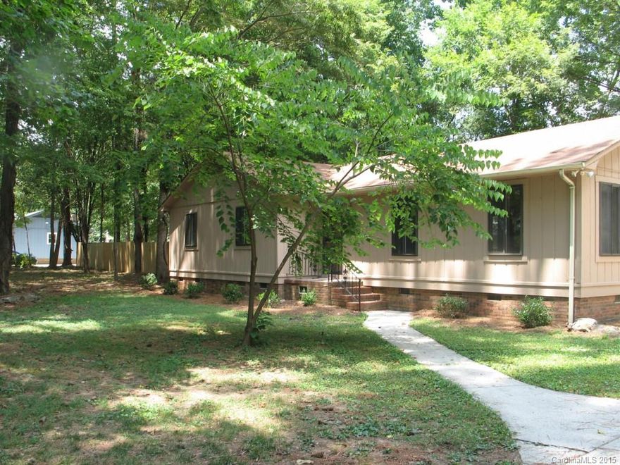Just painted inside and out.  New carpet. Set amongst the trees is this 3 bedroom 2 bath home. Invite your friends and entertain in private fenced back yard or just relax on the large deck. Large great room with a fireplace. 2 bonus rooms for endless possibilities.  Close to Lake Wylie. Seller is motivated so make an offer.