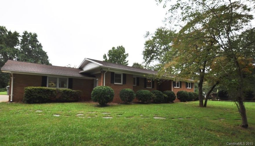 Lovely brick ranch with basement in Belmont. This home has been updated and is fabulous. New kitchen cabinets, flooring, lighting and granite countertops. Cedar lined closet in the foyer. Two fireplaces - one in the great room and one in the finished basement. Hardwood floors in the bedrooms. Two car carport. Large storage shed in huge back yard. Nice setting with lots of pretty shade trees. Great Belmont location, very close to all the downtown activities as well as minutes to I-85.