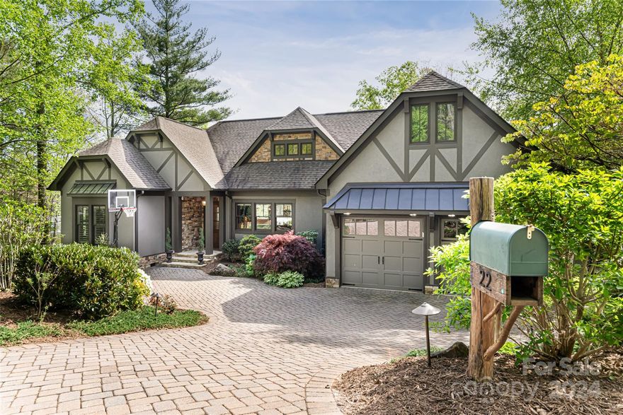 Nestled in Fairview's premier gated mountain community on a large, secluded lot, this exquisite home boasts abundant natural light, offering serene ambiance throughout. Step inside to discover a spacious open floor plan with timeless finishes, elegant built-ins, and plantation shutters. Over 2,200SF of main-floor living space is designed for daily living and easy entertaining. Indulge in the luxurious primary suite featuring a vaulted ceiling, expansive windows framing breathtaking mountain views, oversized soaking tub and heated flooring. Enjoy the convenience of a custom-designed closet for all storage needs. The lower level presents a cozy family room complete with a second fireplace, built-in bar, large guest room, and a dog-wash room. Step outside to the upper/lower decks to relax in the hot tub and enjoy the mountain views. Surround yourself with gorgeous mature landscaping, rock walls, vibrant roses and lush hydrangeas. Experience luxury mountain living at its finest.