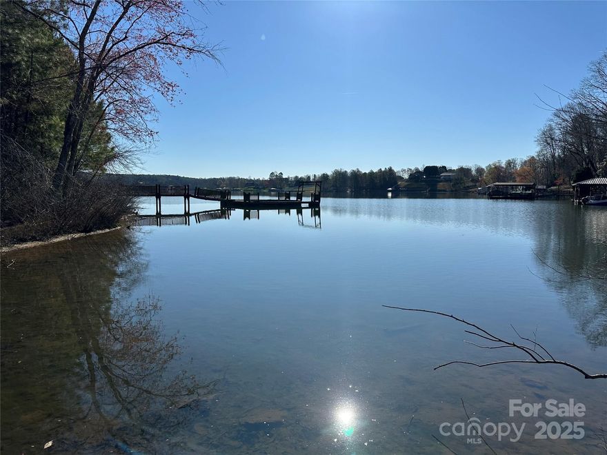 Rare opportunity to own 4+/- acres on Lake Hickory with both lake and mountain-style stream frontage! Tucked away at the end of a quiet cul-de-sac, this wooded and private lot offers a beautiful slope to the lake with a dock already in place. A bold, noisy stream flows along the back of the property — the perfect peaceful escape. Sit by the lake, relax by the stream, or enjoy both — it’s a setting that’s hard to find. County water, underground power, phone & cable available at the road. Previously perked (12+ years ago). Minimal restrictions and no HOA. A rare chance to build your dream getaway on Lake Hickory!