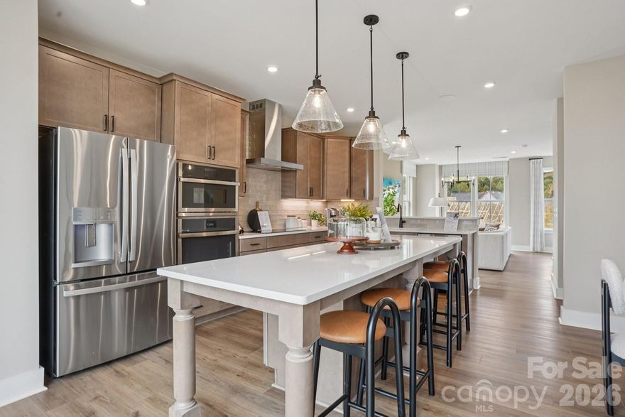Welcome to The River District—a true master-planned community where lifestyle and location come together beautifully.

This beautifully appointed Landon three-story townhome offers a thoughtfully designed layout with a first-floor guest bedroom and full bath—perfect for visitors, multigenerational living, or a private home office.

The second level showcases a gourmet kitchen featuring quartz countertops, a built-in oven and microwave, electric cooktop, and soft-close cabinetry. The open-concept dining and living areas create an inviting space ideal for entertaining, while sliding glass doors lead to your private balcony—perfect for relaxing or enjoying your morning coffee.

Upstairs, you’ll find two beautiful owner’s retreats, each offering a bright, airy bedroom and a spa-inspired bath for ultimate comfort and privacy. A conveniently located laundry area completes the upper level.

This home is filled with beautifully curated interior finishes, individually hand-selected by our professional design team, creating a cohesive and elevated aesthetic throughout.

Location is everything—and at The River District, you’re truly minutes from it all. Planned community amenities include a resort-style pool, clubhouse with fitness center, tennis and pickleball courts, parks, scenic trails, a working two-acre farm with an on-site farmer, and a riverfront amphitheater.

Experience vibrant, connected living in one of the area’s most exciting communities.