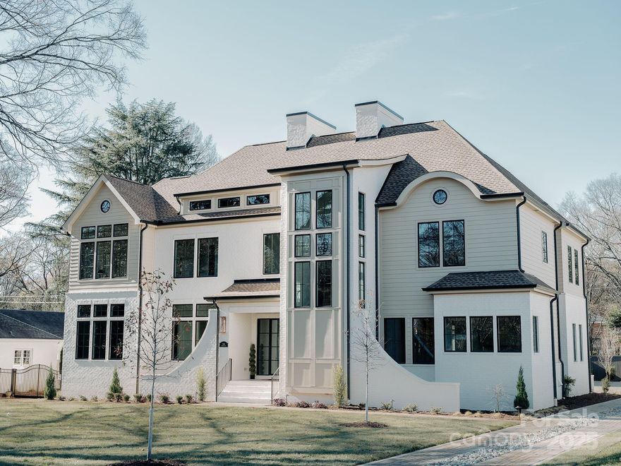 The most jaw-dropping home in Lansdowne? Meet 544 Wingrave: a 5,430 sq ft, 5-bedroom, 6-bathroom stunning new construction brought to you by the esteemed team at Dapper Development. You arrive at this flagship home via a fully paved driveway of impervious pavers, accented by a striking river rock inlay that runs down the center and landscape lighting that shows off the beauty that surrounds this showstopper. The home is outfitted with a full-brick two-car detached garage...EV charger included... as well as a 16X33-foot heated saltwater pool. The interior of the home has an 11-foot primary floor ceiling along with 10-foot secondary floor ceiling and gorgeous custom wood work 22 feet high in the living room . The chef-calibre kitchen is outfitted with marble countertops and backsplash with bronze fixtures, a custom-glass-encased climate controlled wine cellar, and a whimsical tucked-away scullery. The primary suite wing is outfitted with a private office, its own laundry room, a spacious private loggia, and an oversized, beautiful bathroom with his and hers closets. All upstairs bedrooms come with fantastic walk in closets and ensuite bathrooms. Surround sound thought out the home will have you doing a two step while doing laundry in one of the three laundry rooms throughout the house or providing beautiful background music during celebrations. And an encapsulated crawls space to boot! Don't miss out on this opportunity to own a once-in-a-lifetime residence in the heart of one of Charlotte's most admired neighborhoods.