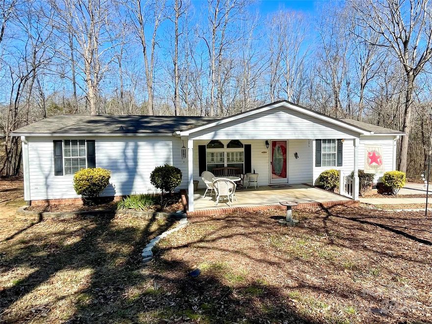 Beautifully maintained home on 1.24 acres in a quiet country setting. The home sits in the cul-de-sac with wooded area behind it. BRAND NEW carpet throughout. Living room is spacious with built-in cabinetry. Kitchen and dining area are open to the living room. Amazing pantry and plenty of countertop workspace for cooking in the kitchen. Stove and dishwasher are approximately 5 years old. Primary bedroom with large walk in closet. Primary bathroom has oversized vanity with dual sinks, walk-in shower, built-in linen cabinet, and garden tub. Secondary bedrooms share a hall bath. The laundry room offers extra storage space. This home gets great natural light. Quaint front porch perfect for enjoying the outdoors in the shade. Spend time on the deck grilling or watching the wildlife. Lots of parking spaces in the driveway. Roof-April 2022.