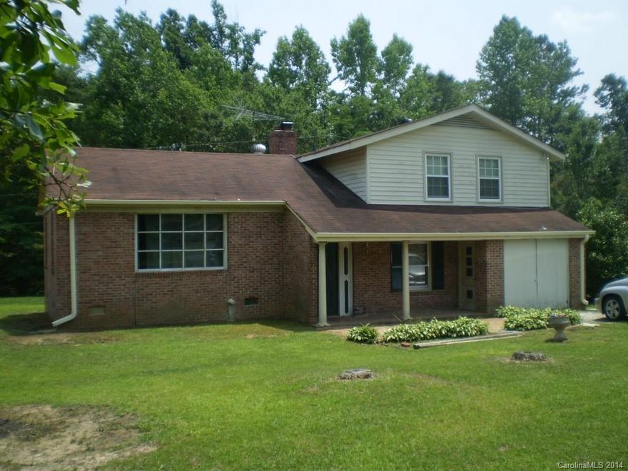 Large attractive lot with fixer upper home with lots of potential.  Located in the county.  Property to be conveyed as is.