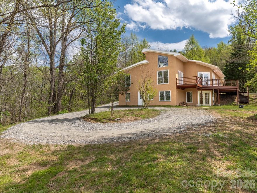 Welcome to 76 Raven Rock—a rare opportunity to own a private retreat on 3.74 acres perched along a dramatic cliffside, overlooking the French Broad River. Enjoy the peaceful sounds of the river right from your own front yard.
One of the most special parts of this property is the constant connection to nature. With regular visits from wildlife including owls, deer, wild turkeys, hummingbirds, pileated woodpeckers, and even great blue herons, right from the your deck. Just a short walk away, the cliffs offer a setting that feels like a private state park, perfect for exploring and taking in the beauty of the area
The home is a thoughtfully designed PASSIVE SOLAR home constructed with Rastra block, creating exceptional energy efficiency. RASTRA Insulated concrete forms are energy-efficient decreasing energy consumption by up to and above 50%. The property features terraced gardens and offers incredible potential for creating an outdoor living space, expansive patio, or even a second home for added income
Inside, you’ll find tall ceilings, original hardwood floors, tile floors, and a strategically placed JOTUL wood stove that enhances both comfort and charm. Cozy up by the fire with a good book in the reading nook and watch nature just outside your huge windows. Lots of natural lighting for the passive solar just invites nature inside. This 3-bedroom, 3-bathroom home also boasts a brand-new kitchen and freshly painted interior, making it move-in ready. 2 large, main level bedrooms, each complete with ensuite baths.
Located in the same neighborhood as the renowned PRAMA Institute, a nationally recognized wellness destination. Another priceless benefit is sharing trails with Prama and having access to their weekend wellness programs, adding a unique sense of community and lifestyle to the experience. Whether you're seeking a peaceful homestead or a lucrative short-term rental, this property delivers.
Despite the sense of seclusion, the location is incredibly convenient. We’re just 10 minutes from downtown Marshall and a short drive to Asheville, with easy access to the Ivy River for trout fishing and swimming holes, as well as nearby Hot Springs and the Appalachian Trail. It’s rare to feel so tucked away while still being close to everything.
(Check out our video of the home and downtown Marshall: https://youtu.be/44LenZY_Gf0)