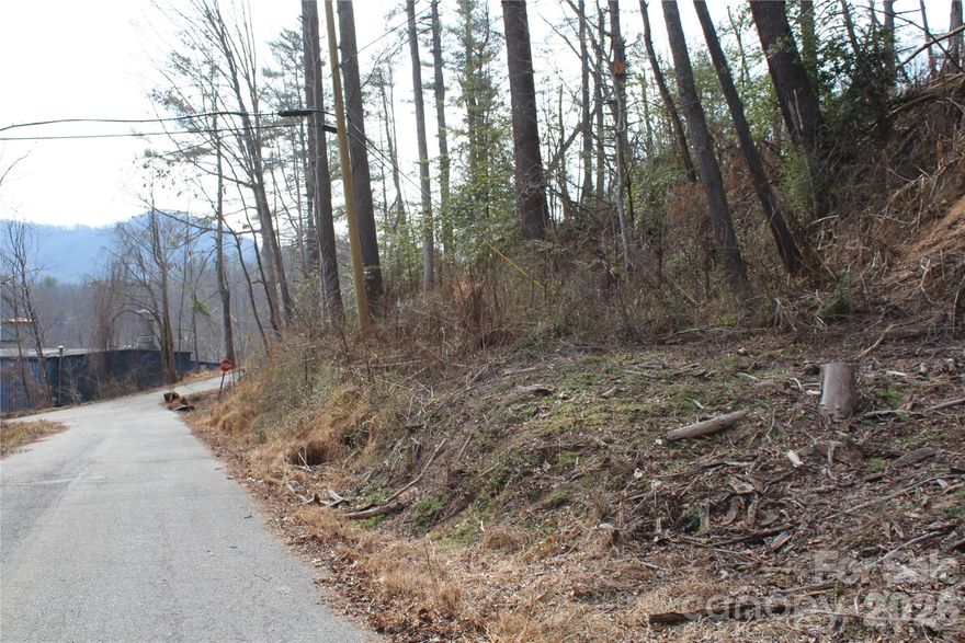 Discover this prime 1.37-acre parcel nestled within an established neighborhood, just a short walk from the vibrant heart of historic downtown Spruce Pine. The property sits on a desirable corner lot, offering paved, state-maintained road frontage for easy, year-round access. City water and sewage are available at the street, with tap fees required, and electricity is already on-site, ensuring a smooth start for your custom home build.
Enjoy the convenience of being close to Spruce Pine’s walkable downtown, where charming shops, galleries, and local eateries create a welcoming and lively atmosphere. This area is perfect for those seeking both relaxation and adventure, with unique stores, artisan boutiques, and regular community events that celebrate the town’s rich history and mountain scenery. Whether you’re looking to build your dream home or invest in a growing community, this land offers the perfect blend of location, accessibility, and community spirit.
