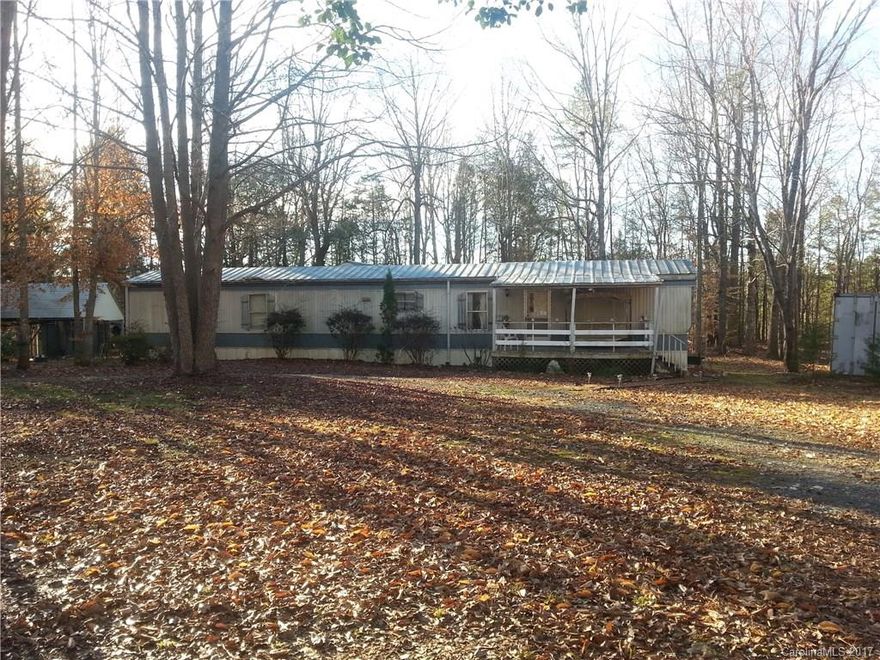 Single wide mobile home on (owned) 3/4 acre lot, in Waxhaw, NC, NO HOA, Well, Septic, 2 BR, 2 Full Bath, Cover porch and Deck, Circle drive, Carport, outbuildings.