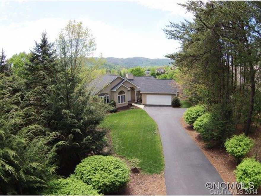Luxury home in the Reems Creek Golf Community w/panoramic mountain & golf course views where inside you will find a light & bright open floorplan w/a vaulted great room, skylights, a gourmet island kitch w/granite countertops & stainless appliances, a luxurious main level master suite & an in-law suite in the basement w/kitchenette. Enjoy entertaining on the open deck or relaxing on the screened porch & being just minutes to downtown Weaverville.