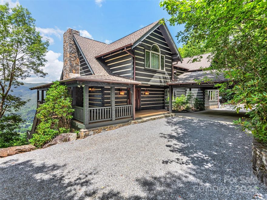 Situated in the gated Smoky Mtn Retreat at Eagles Nest, this exceptional hand-hewn authentic log home is currently configured as a 7-bedroom, 4.5-bath residence (4-bedroom septic permit). In pristine condition, the home features a circle driveway, an impressive porte-cochère, and a welcoming covered front porch. Inside, you'll be greeted by breathtaking short & long range mountain views, a spacious great room, & a stunning floor-to-ceiling native stone fireplace. The main floor includes granite top kitchen w/ spacious bar, SS appliances, & ample cabinetry, a spacious dining area which seats 8, a guest room or office, and a huge primary suite w/ stone fireplace, french doors to covered porch, & double vanity bath w/ tile shower & separate soaking tub to enjoy Mtn views from. Upstairs includes a den/library, huge guest suite w/ high end bath, & two additional guest rooms w jack & jill bath.Lower level boasts huge family room w/FP, a rec room, Bath, & 2BR's. House is being sold turn key.