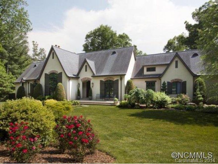 Spectacular Jack Arnold tudor inside the guarded & gated Ramble Biltmore Forest sited on just over 2 meticulously maintained acres with gardens & stunning water feature. One of a kind fireplaces, exquisite lighting. Amazing master suite, offices and full gourmet kitchen open to full dining wing, great room. Quality, detail & seldom found location. Must see to appreciate. Newly installed solar power/generation station.