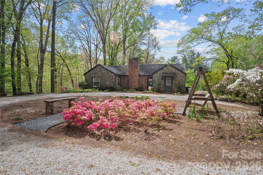 Welcome to your own private retreat! If you’re seeking tranquility, comfort, and timeless charm, this beautifully restored stone cottage offers it all. Built in 1942 by local Native American masons, this 3-bedroom, 2-bath home, perfectly situated on over 8 acres, seamlessly combines historic craftsmanship with modern updates.  Step onto the expansive screened porch and take in sweeping mountain and nature views—the perfect backdrop for morning coffee or evening relaxation. Outdoor amenities include a large detached garage/workshop, 2 additional outbuildings, and an inviting in-ground pool for summer enjoyment.  Inside, the home features a spacious kitchen with updated appliances, an oversized stainless steel sink, abundant counter space, and excellent storage. The adjoining dining area easily accommodates a table for 6–8 and frames beautiful mountain views. The generous living room offers both comfort and warmth, complemented by a recently installed wood-burning stove ideal for cozy winter nights.  The primary suite includes a private ensuite bath, while two additional bedrooms and another full bath provide ample space for guests or family.  Recent updates add reliability and peace of mind, including new HVAC (2022), whole-house generator (2024), foundation reinforcement (2024), new pool pump (2025), well pump replacement (2025), and a new garage roof (2025).  This property embodies a rare blend of history, character, and modern convenience—ready to welcome you home.  Property is privately located in between the charming towns of Columbus and Tryon, just off of Skyuka Rd., and is wonderfully landscaped with a nice mountain creek running along one of the borders.