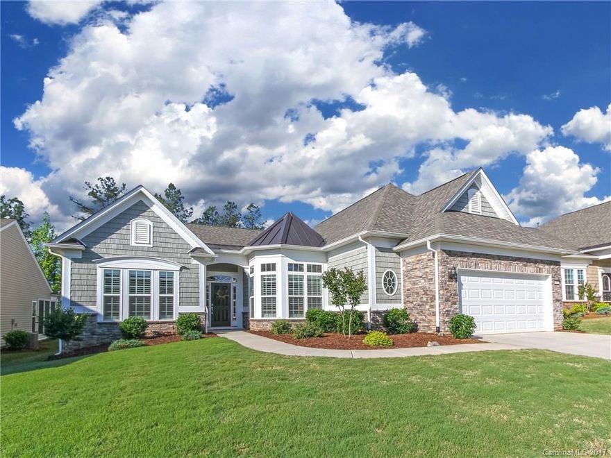 Like-new Cumberland Hall in 55+ Sun City Carolina Lakes Community. Open floorplan features eat-in kitchen with SS appliances-including cooktop stove & wall oven, custom tile backsplash, island & serving bar, dining nook & pantry. Formal dining room opens to light-filled great room w/ corner fireplace & plantation shutters. Luxurious master suite features wall of windows, huge walk-in closet, & attached bath w/ upgraded tile walk-in  shower. The lovely 3-Season room is a great addition!