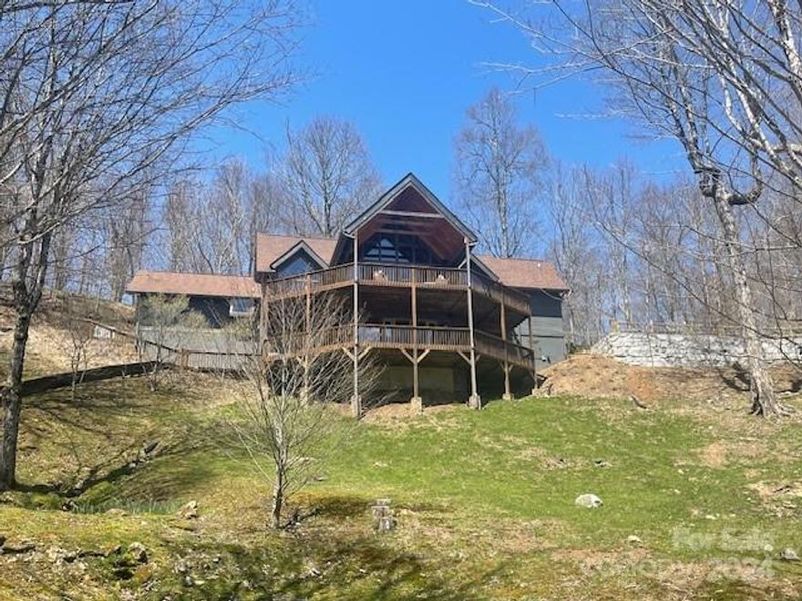 Stunningly appointed custom home with over 3300 sqft with many upgrades located on corner lot with all paved frontage and mtn views. 3 levels, featuring 3 bedrooms and a bonus/ bedroom spacious primary w/fireplace on main level-oversized custom closet and central A/C and mini split climate controlled. Gourmet kitchen with appliances that match cabinets, butler's pantry/wet bar w/sink/fridge, ice maker, wine fridg. with views. Laundry/pantry room . Extensive updates with engineered wood floors, new baths, new kitchen, and more.  Vaulted ceilings with impressive post and beam, tongue and groove. 2 primary bedrooms on lower level. There are upper and lower decks, partly covered with views. The property boasts mature landscaping, and all paved access for year round convenience.  The home is equipped with a generator, member of the Village Club Amenities, making this a total package for the discerning buyer.  Non brokers must be accompanied for security gate.  Se RPD for HOA for contacts