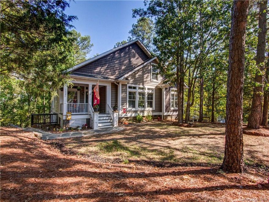 SPECTACULAR home in the heart of Tega Cay! Beautifully maintained w upgrades incl porcelain tile in master & half bath, walk-in tile & frameless glass shower, new kitchen backsplash. HW throughout main living area, large windows for lots of natural light, open floor plan, large kitchen w SS, custom cabinets, Corian counters. MB on main level w spacious en suite oasis. HUGE walk-in closets in bedrooms. Oversized garage w built-in cabinet work bench. Steps away from clubhouse! All this & no HOA!