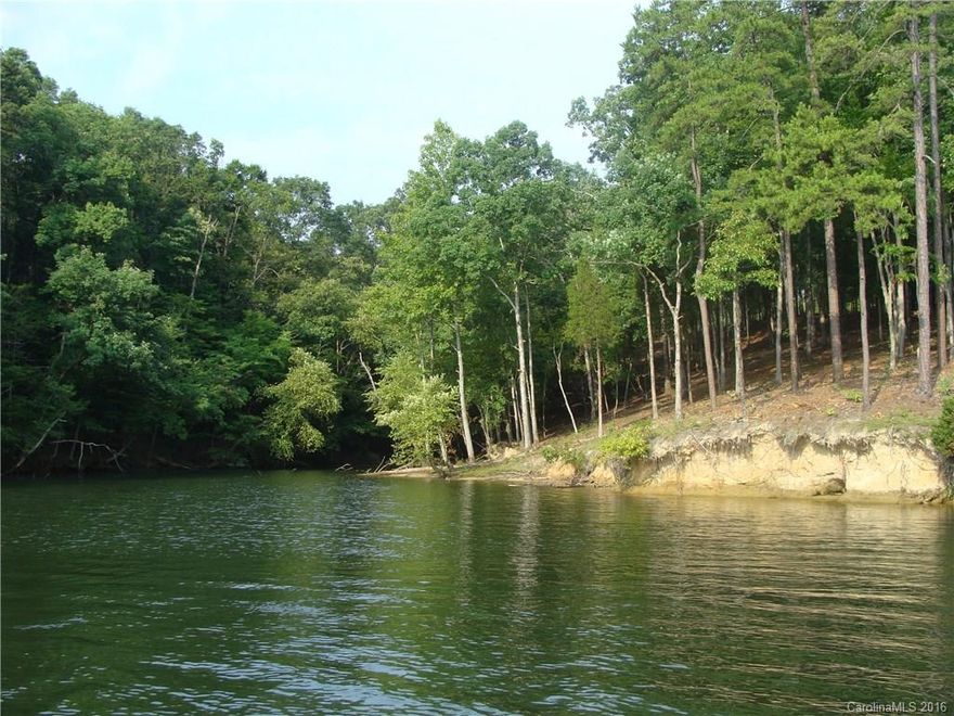 Looking for a large waterfront lot on a quiet cu-de-sac street with deep water and sandy beach shoreline to play
on? Then this is for you! This dockable lot is over 1.2 wooded acres on a deep water cove just off the main
channel. Easy commutes to Charlotte and it's International Airport. Depending on your desired building location
this lot would allow for you to build a basement or crawl foundation home. Build anytime, bring your builder or
use one of mine! Low taxes and great schools!