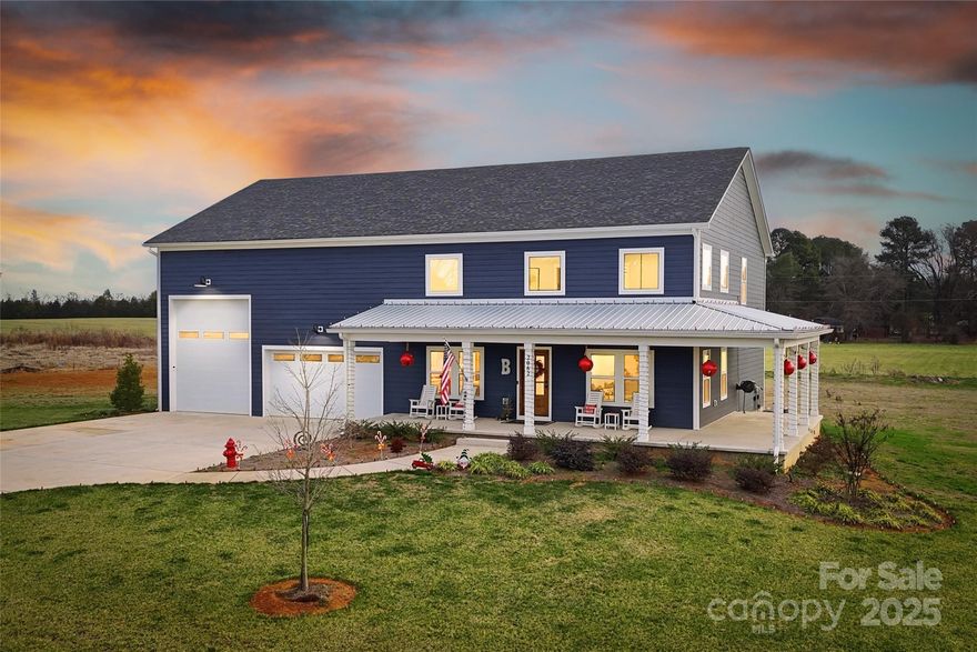 Nestled on over an acre and a half, this stunning barn dominium-style home exudes curb appeal that is sure to captivate!!

Built with care, this stick-built construction combines rustic charm with modern elegance. As you step inside, you are greeted by a massive open living area, accentuated by beautiful exposed wood details and bathed in natural light that pours through large windows, creating an inviting atmosphere with soaring ceilings.

The kitchen is truly a chef’s dream, featuring a large island topped with exquisite quartz countertops, perfect for culinary creations and entertaining guests. Open shelving adds a touch of modern flair, while a spacious pantry provides ample storage for all your cooking essentials. The main level continues with a functional mudroom complete with a wall tree, a well-appointed laundry room featuring cabinets and a sink, and a convenient half bath for guests.

Retreat to the primary bedroom, where a large walk-in closet offers plenty of storage. The primary bathroom is an oasis, showcasing a dual vanity with ample counter space and a massive tile shower, perfect for unwinding after a long day. A custom open staircase with sleek cable railing leads you to the loft area upstairs, which includes two additional bedrooms, a full bathroom, and extra living space.

The garage is another highlight, boasting roughly 1,400 square feet of heated and cooled space. With two pull-in doors, including an oversized door designed to accommodate an RV, camper, or boat, this garage provides unmatched versatility.

This home seamlessly blends functionality with style, making it perfect for those who appreciate both spacious living and modern amenities. Don't miss your chance to own this remarkable property!