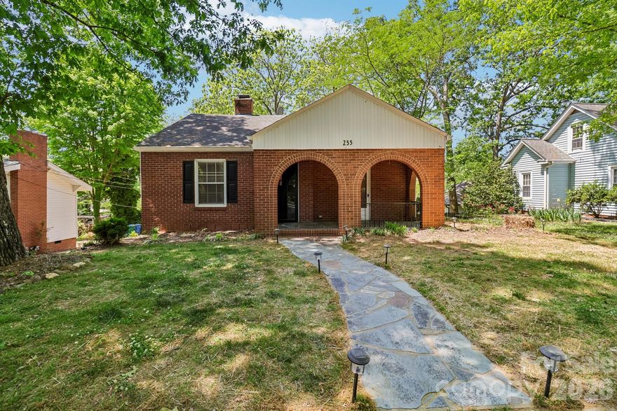 This charming 1930s full brick cottage offers the perfect balance of historic character and modern convenience. Located just a short distance from the heart of downtown Albemarle, the home features beautiful architectural details like classic brick arches that lead onto a spacious covered front porch. The inviting dining room includes elegant French door that open directly onto this porch, making it an ideal space for entertaining or enjoying a morning coffee.

Inside, the living room serves as a centerpiece with its cozy fireplace and beautiful arched built-in bookshelves that reflect the home’s original craftsmanship. Throughout the main areas, original hardwood floors maintain the authentic feel of the era while flowing into the updated living spaces. The interior has been thoughtfully improved with a brand-new kitchen and a fully renovated bathroom, providing contemporary comfort in a vintage setting. With three comfortable bedrooms and a full basement for extra storage or workshop space, this property is a move-in-ready opportunity to own a classic masonry home in a prime location.