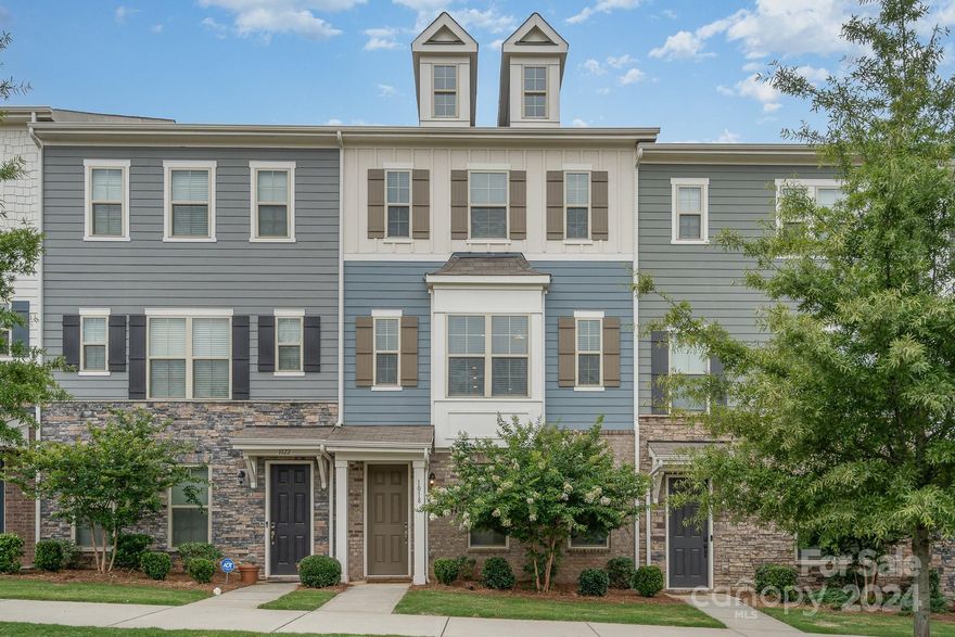 Dreaming of taking the Light Rail to work? Look no further than this gorgeous townhome in the Hadley at Arrowood Station community! Three floors of beautifully modern features await. The ground-level floor has a drop zone to contain the day's clutter right inside as you come in from the 2-car garage, and a guest or in-law suite. Upstairs you'll find a beautiful open kitchen and living space, with TALL ceilings, fully appointed kitchen, huge pantry, beverage bar, and your private balcony. Continue up to the top floor for your spacious primary suite and another bed and full bath. The front of the house faces a large open park space. Plenty of parking for your guests when they come over to spend a day at the community's pool with you. And did we mention the light rail station just up the hill from your house so you can get to work (or play) uptown with ease? Most of the furnishings present in the home at time of showing are available with the home as well! This townhome is READY for you!