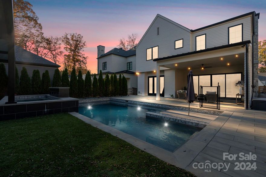 This Stunning Modern Luxe home in the heart of Cotswold built in 2020  features 5-bedroom, 4.5-bath and blends luxury and lifestyle perfectly in one of Charlotte’s most desirable neighborhoods. The open-concept design is ideal for entertaining and everyday living, with 10’ ceilings, an elegant office, a drop zone, motorized shades, and a beverage fridge. The chef’s kitchen shines with a waterfall island, quartz countertops, backsplash.Gleaming hardwood floors showcase impeccable craftsmanship throughtout. Step outside to a backyard oasis featuring a saltwater pool with LED lighting, tanning ledge, spa, artificial turf, a fire pit, and a covered patio for year-round enjoyment. Upstairs, find 3 ensuite bedrooms, a Jack and Jill bath, and a primary suite with a spa-like bath, soaking tub, walk-in shower, dual vanities, and a custom closet. Sonos technology and energy-efficient features like an encapsulated crawlspace enhance comfort. Minutes from Southpark and Uptown Charlotte.