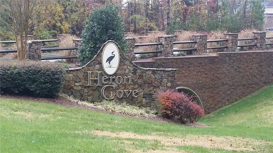 Great rectangle lot in beautiful Heron Cove in Lake Wylie. The lot will have trees in the back and at least 99ft across the front. It's located a very short distance to the Lake Park where there is a fire pit, canoe launch and more. The swimming pool is open during the spring and summer months. Former contractor said home could be built with a walk-out basement or a tall crawl space.