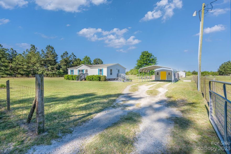 Bring your horses and come to quiet, serene living. Three bed, two bath manufactured home sits on 3.75 acres completely fenced for your fur babies or equestrian friends. Property features a 24 x 48  three stall equestrian barn with tack room and hay storage. There is also a 12 x 24 wired storage building and a 10 x 12 building currently being used as a pet grooming salon. This home is in the sought after Andrew Jackson school district.  Come enjoy country living at its best!