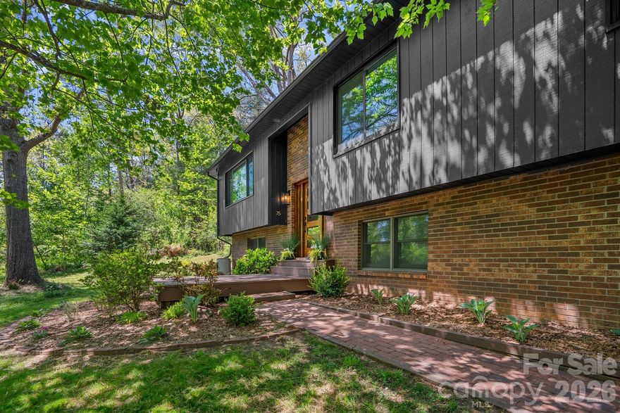 Extensively renovated from top to bottom, this private 3BR/2.5BA home on 1.35 acres offers true move-in-ready living with significant upgrades already completed. Just minutes from Asheville, it delivers rare privacy, flexible living space, and long-term value with room to garden or expand.  Set well back from the road, this  home combines modern updates with a peaceful, nature-filled setting. 

The main level was opened up to create an easy flow between living, dining, and kitchen spaces. The redesigned kitchen features quartz countertops, shaker cabinetry, an oversized 8.5’ island, walk-in pantry, under-cabinet lighting, and fixtures from West Elm and CB2. All bathrooms were rebuilt down to the studs with clean, modern finishes, and the former laundry room now functions as a combined powder room and laundry space with updated fixtures and appliances.

The lower level adds flexibility with a spacious second living area w/wood stove is ideal for a den or guest space, 

Upgrades go well beyond cosmetic. Improvements include new LVP flooring throughout, solid interior doors, removal of popcorn ceilings, and a rebuilt entry stairway with solid wood treads and modern railing. Most all windows were replaced with black Andersen Windows casement and sliding windows in 2021 with a 25-year transferable warranty. Additional work includes chimney repair in 2021, exterior paint in 2022, resurfaced driveway in 2026, and a sump pump added in 2025 with a transferable warranty.  Outdoor spaces are just as considered, with new front and back decks, a fully fenced yard with gate, and plenty of parking including a two-car garage and oversized areas for RVs, boats, or multiple vehicles.  The land is what truly sets this property apart. The 1.35-acre private lot offers space for gardens and outdoor living. Native plantings, stone walls, mature trees, and cleared areas attract birds and pollinators, along with frequent wildlife sightings that reinforce the sense of retreat.