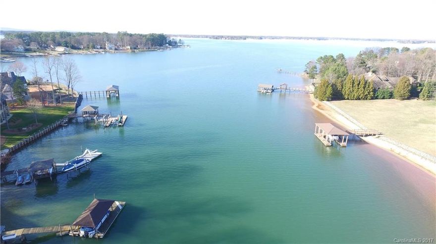 Open floor plan & awesome lake views. Price adjusted! Must see! Great location Waterfront 4+ bedrooms, close to shopping, Hwy 77. No HOA, Hardwood floors & new carpet on Main level, updated kitchen, Granite, SS Appliances/Large Island.  Wet Bar in Formal Living Room. Huge Owners Suite with Adjacent Office/Workout Area. Fully finished walkout basement bar/kitchenette. Water views from almost every room! 1.25+/- acres, pier, tiered deck and tons of outdoor space to enjoy the beauty of Lake Norman!