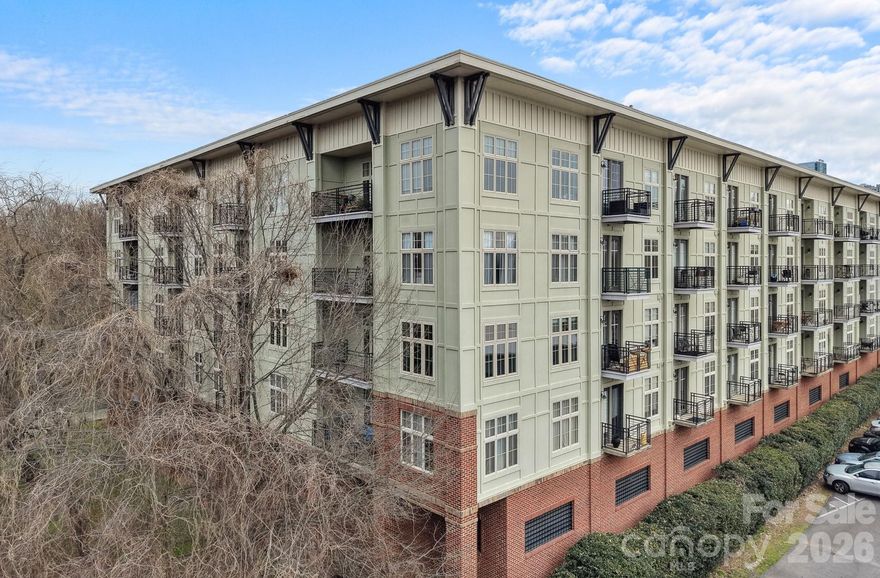 In the heart of 3rd Ward and truly walkable to Uptown, this 2-bedroom, 2-bath corner condo puts the city at your doorstep. Catch a Panthers, Charlotte FC or Knights game, hit the greenway, grab coffee or dinner, all without moving your car. When you’re ready to slow it down, come home to a space that feels bright, open, and easy. New lighting throughout and an updated kitchen with new countertops and appliances give it a fresh, modern look that flows seamlessly into the living area. Large windows bring in natural light and the covered balcony is the perfect spot to start or end your day. The mature trees lining the edge create a peaceful retreat just minutes from the energy of Uptown. Both bedrooms feature new carpet for a clean, comfortable finish. The interior courtyard offers grills and seating areas with skyline views peeking over the building. Frazier Park, with a playground, dog park, walking trails, tennis and basketball courts, sits right next door. Secure elevator building with key fob access and gated garage parking, including one assigned space. Fully move-in ready with the refrigerator, washer, and dryer included. A rare chance to get location, updates, and true walkability all in one.