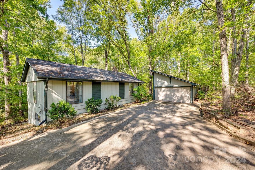 Welcome to this charming ranch with a basement, nestled on a private 2 Acre wooded lot! The main level features a cozy bedroom with its own fireplace, a full bath, a kitchen, and a living room with gorgeous hardwoods that extend into the bedroom. Enjoy your mornings or evenings on the screened porch, offering a peaceful retreat with views of nature.

The lower level expands the living space with two additional bedrooms, a full bathroom, a family room with a second fireplace, and a laundry closet. Step outside through the sliding glass door for easy access to the outdoors.

A detached 2-car garage offers extra convenience and storage. Don’t miss the opportunity to own this unique property—book your showing today! Previous buyer's inspection report available upon request.