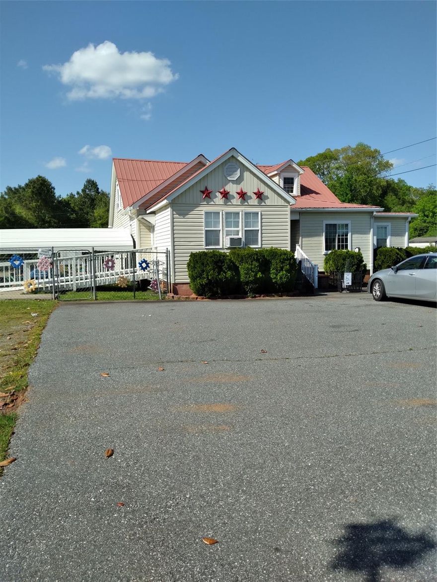 Formerly use was a day care licensed for up to 28 children for 2 shifts.  Because of not being located in any city limits, the property is unrestricted, may be used as residential, office space, or retail.  Excellent highway exposure on Main Street and Walter Horn Road.  The 4.98 acres is excellent for residential development with public water available.  Carport, children's playground equipment, and storage shed to remain if needed.  Building needs updating.
Building could be a 4 bedroom, 1 full and 2 1/2 baths.
