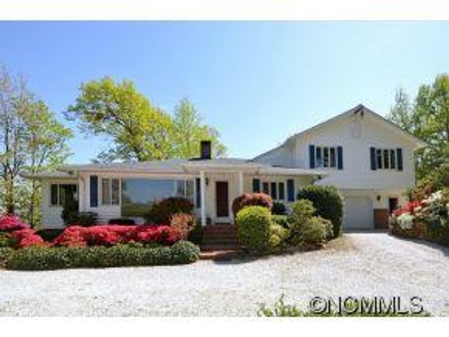 BREATHTAKING MOUNTAIN VIEWS! Private 4 BR 2.5 BA spacious home on nicely landscaped,level land w/ ample parking. Antique brick fireplace & original oak paneling in the spacious living/dining room, 4 season sun room & a first floor master. House sits nicely back from the road with easy access & a large 2 car garage. Enjoy the cool mountain air just a short drive from Tryon village. Community water.