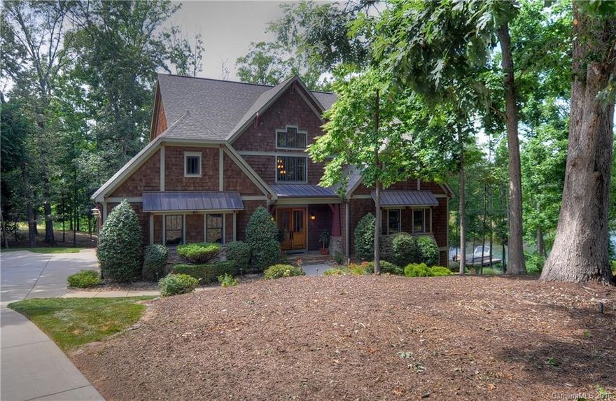 Prepare to relax in this stunning home that sits on a private 1.35 acre wooded lot.  Adjacent to #8 tee on TNGC and Lakefront with private pier.  Open floor plan with extraordinary details throughout. Chef's kitchen with professional grade appliances, unique ceiling features, second kitchen on lower lever, laundry on main and lower levels, 3 fireplaces (wood burning on screened porch), billiards room, media room.  Lower level can be used as 2nd LQ.  Large bonus room up and lots of storage.