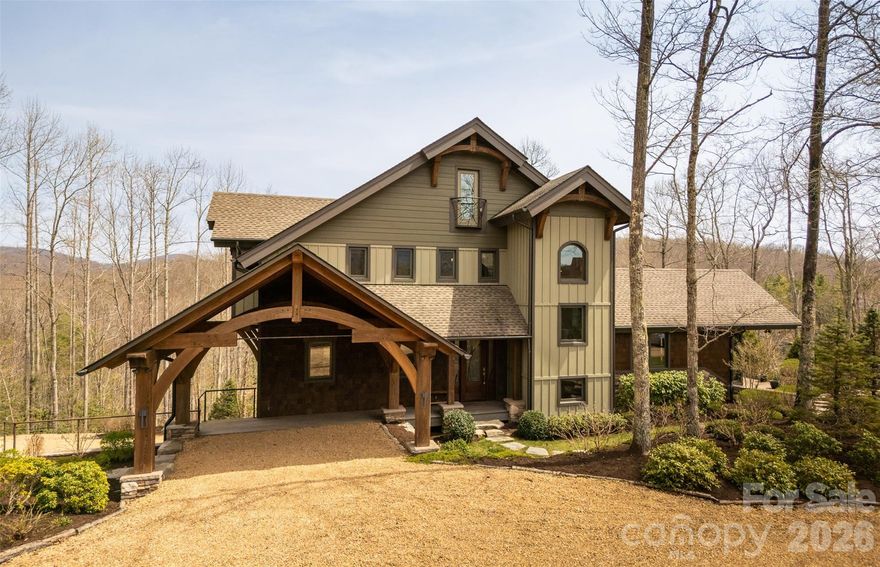 ENJOY ELEGANT MOUNTAIN LIVING WITH VERY VERY LOW ENERGY COSTS YEAR ROUND WITHIN THE DESIRABLE, GATED COMMUNITY OF SWEETGRASS, 10 MINUTES FROM DOWNTOWN BLOWING ROCK. Custom built home in one of the best and largest lots in Sweetgrass, complete with its own small pier on the lake. House is nestled in on the point, both overlooking the lake, the dam, and the national forest, and surrounded by tasteful landscaping designed by Sonya Garland. Indulge in the luxury of staying warm all winter with virtually “free heat”. THIS HOME IS BOTH HIGH-TECH and NET-ZERO/OFF-THE GRID. TYPICAL UTILITY COSTS PER YEAR IS ONLY $800 (with a usage rate of 2 long weekends per month, and multiple week-long stays throughout the year with many guests, and keeping it at 68 degrees in the winter while away.)

The thoughtful design makes this home “live” much bigger than what one would expect from the photos and its stated square footage. Open floorpan throughout but still feels cozy with the wood beams, warm cabinetry, and various living areas and flex space to cater to changing needs. Built-in sound system throughout the house. Primary bedroom and laundry on main floor, designed for retirement.

Enjoy virtually “free heat” via radiant floor heating throughout is served by solar thermal panels that provide all of the heat and hot water for the house. Complete with (2) 90-gal. storage tanks for hot water, you will never run out.  So much so, that the hot water overflow goes to the entire basement floor, keeping that level dry in the summer and warm in the winter. This makes it very comfortable for anyone working on hobbies or projects year-round. There is also a 500 gal propane tank and boiler as a backup for the heat, fireplaces, stovetop and grill connection on the deck.

This home has solar photovoltaic (PV) panels that provide electricity, as well as a brand new Tesla PW3 battery (with 13.6KWH capacity) that powers the emergency panel, (which is charged by the grid when the utility power is on, and the solar PV system when it is off.) 4 electrical panels in the house w/ one serving as an “emergency” panel that is connected to the battery (running the controls to the house, some lights, some items in the kitchen, and the home theatre.) Most of the lighting is LED downlighting with remote power supplies in 3 discrete locations.

This net-zero home is complete with an electric vehicle charger in the garage, making it virtually free to travel to/from your mountain retreat.

The home is operated by a Control 4 operating system, that can easily monitor and control many systems remotely via an app on your phone, or the tablet in the kitchen.  It can monitor, control, and design lighting and heating preferences, access the security system and cameras, door locks, music, TVs, home theatre, etc.

Spacious kitchen has lots of workspace, ample cabinetry, large island, and a walk-in pantry, w/ an excellent work flow to handle multiple chefs cooking in the kitchen at the same time. Living area boasts vaulted ceilings, a gas fireplace and overlooks to the lake. The screened-in porch also has vaulted ceilings, wood-burning fireplace (w/ a gas starter) with views of amazing sunrises, and wildlife grazing along the dam and creek.  The basement level has a large home theatre with a 4k projector, incredible sound system, tiered platforms for seating, and 8 powered reclining chairs.  Over-sized, heated 2-car garage, 2nd refrigerator, and workshop area, mechanical room, and extra storage closets.

At the center of the Sweetgrass community is a 22-acre private lake, suitable for canoeing, kayaking, swimming or fishing. It has approximately 3 miles of maintained hiking trails, making it a great place to walk dogs or get in a quick hike with friends without having to get in the car. There is access to trout-stoked Boone Fork Creek, and a community clubhouse with a fitness centers, gathering space, etc. Trail map is attached

House is being sold fully furnished.