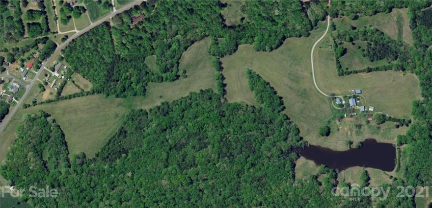 130.66 acres that would be suitable for residential development, farm, private estate, and more. 13 separate parcels that are being sold together. Seller will not split or sell off separate parcels. Modular home, older homes, large workshop (that could also be used for community center), barns, storage sheds on the property are being sold at no monetary value. Shed at front left of modular will be moved. 2 exits to I-85 within 2 miles of property. Majority of land is cleared with some wooded area. There is a large pond on property. Small parcels at back of pond are in flood zone. Per county pond may be used as a water source, no water shed requirements, no fire hydrant needed d/t within 5mi of Level 2 Fire Station. Land starts at end of main road. Min lot requirements 20,000 sqft.
