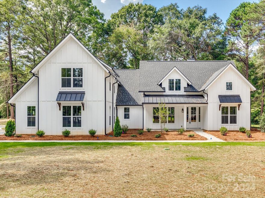 This one has it all: privacy, location & it's brand new! Stunning 4BR/3.5BA on 1.15 acre level, wooded lot! Superior features & standards throughout this home including: luxury RevWood flooring (It's fade-resistant, scratch-resistant, & water-resistant!), Shaker-style cabinets w/dovetail, soft-close drawers, Quartz countertop in kitchen with gas range. The floorplan is an open kitchen concept to the GR & formal dining-perfect for entertaining. Vaulted ceiling in Kitchen & Great Room w/gas fireplace. The Owner's suite on main level with a vaulted ceiling, Revwood flooring, large semi-frameless glass shower, stand alone soaking tub, dual sink vanity & large walk-in closet. Split BR flr plan w/ 2 secondary BRs on main. Large laundry room on main w/utility sink. Upstairs you'll find a large 4th BR/bonus room with full bath. Additional perks: front & back covered porches & side-load garage.  Virtually staged photos are renderings to depict builder standards, color/patterns will vary.