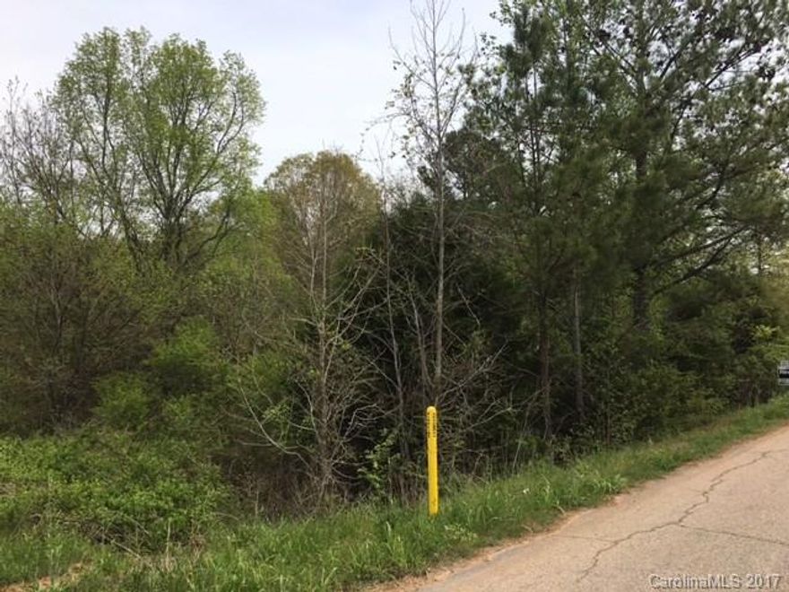 Level, wooded 1.5 acre lot in Harmony Hills Subdivision.  Mobile and Modular home approved.