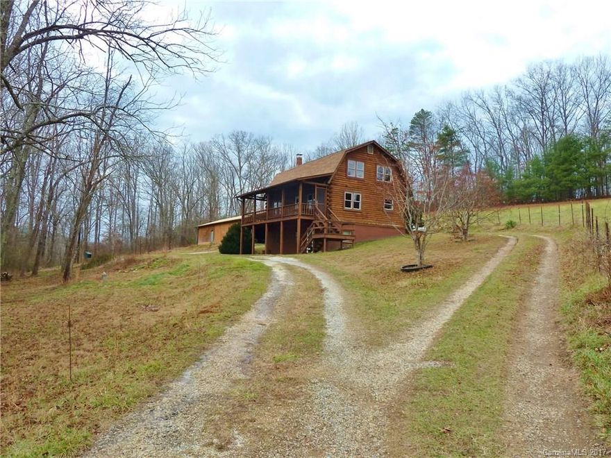 Unique piece of property, an affordable equestrian retreat or mini farm Cane Creek Valley. Just 20 minutes SE of Asheville, with a 3 bedroom 3 bath log home, this property has a lot to offer: large living spaces, 2 generous bedrooms, & a 3rd bedroom in the lower level with walk out access for in-law suite potential. The house & spacious garage, with it's attached 3 stall barn, are on 3.38 acres.