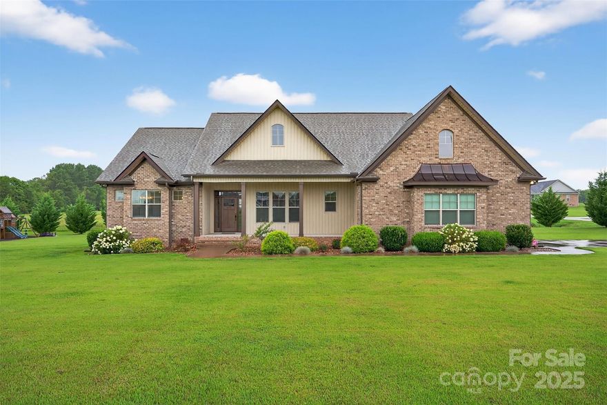 Beautiful 3-bedroom, 3-full bath home with versatile flex space, situated on a spacious 1-acre lot in Cowpens. This property is filled with custom features including ¾-inch hardwood floors, a rocked gas fireplace, copper roof accents, custom cabinetry, granite countertops,ceramic tile, and vaulted/tray ceilings throughout. The open kitchen includes a walk-in pantry and flows into a large laundry room with a utility sink for added convenience. Step outside to enjoy a covered back porch, saltwater pool, and playground—perfect for entertaining,relaxing, or family fun. The master suite features tray ceilings with crown molding and cove lighting, two oversized walk-in closets, a garden tub, a custom tiled shower, and double vanities. Bedroom 2 also boasts a large walk-in closet, and there are four additional storage closets throughout the home. A flexible room—complete with a nearby full bathroom and closet—offers endless possibilities: a fourth bedroom, guest suite, or private home office. All major appliances (washer, dryer, refrigerator, stove, microwave, and dishwasher)will remain with an acceptable offer, making this home truly move-in ready. The level backyard is ideal for kids, pets, and outdoor fun—from running and playing to relaxing by the pool. It’s also perfect for gardening or future outdoor living projects. Located in a quiet area near I-85, between Spartanburg and Gaffney, this home offers space, privacy, and convenience.