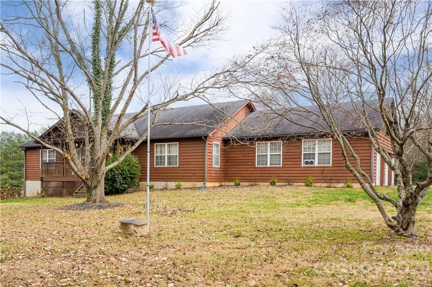 Traditional ranch situated on a 1.73-acre level corner lot within minutes to I-26. The spacious great room with cathedral ceilings and a wood burning fireplace invites you into the home. The open floor plan leads to a large kitchen with breakfast bar and center island. Park in your main level 2-car garage to enter right into the laundry/mudroom hallway, or in the basement garage to access a sizable workshop or storage area. A roomy primary bedroom has its own en suite bathroom and two generous walk-in closets. The split floor plan layout offers privacy from the two other main-level bedrooms and full bathroom. Downstairs you will find a finished basement bonus room that could be used as a den, office, playroom, etc. The acreage is ideal for gardening or outdoor recreation with no restrictions on the property. Sit and relax on the back deck and imagine all the possibilities for this property. *Back on Market at no fault of the seller*
