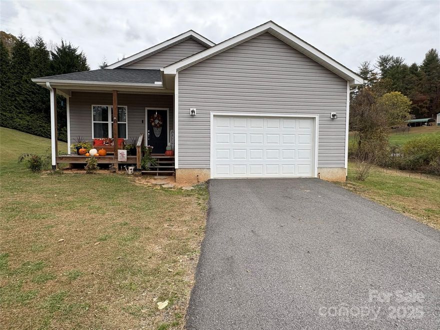 Cozy and well-kept 2-bedroom, 2-bath home in the peaceful Petersburg area of Marshall. This 1,240 sq. ft. single-family home offers a spacious floor plan on a beautiful cleared lot just minutes from Mars Hill University, Wolf Laurel Ski Resort, and only 30 minutes to vibrant Asheville. Features include a comfortable open layout, bright living areas, and an attached 1-car garage. Enjoy great outdoor space perfect for gardening, entertaining, or relaxing in the mountain air. Ideal for first-time homebuyers, investors, or anyone looking for a downsized mountain retreat or vacation home in desirable Western North Carolina.