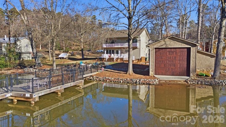 This SPECIAL lake front 2 bedroom + a flex room property feels like NEW with OVER $400K in renovations, sits on a large lot with NO HOA and includes one of the LARGEST pull through BOAT HOUSES on the entire lake (with PRIVATE boat ramp)! Gourmet kitchen appliances/beautifully landscaped firepit/brand-new Trex pier/extensive circle drive/All-new HVAC/electrical/plumbing/natural gas service/roof/tankless water heater/brand-new floor-to-ceiling finishes throughout & MORE!  Enjoy modern efficiency, quality craftsmanship, and true turnkey peace of mind in a prime lake setting. Easy almost LEVEL walk to water!  Pier permit with Cube Hydro: $100 annual renewal fee. One-time $175 pier transfer fee to be paid by buyer at closing.  Preapproved buyers welcome!