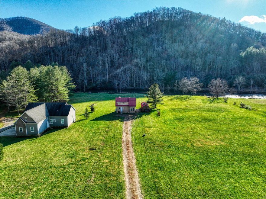 The storybook cottage is a great description of this home, with easy access to the new river just off your back porch. Tiny but 2 bedrooms 2 baths, kitchen, and living area. The seller also had the outbuilding as a tiny home at one time. Partly powered by solar panels makes this home efficient for owning a second home in Ashe County. River frontage is approximately 105 ft, with large acreage leading to the river to play sports, read, and relax while family members play in the river. The New River State park is across the river therefore your view will never change at this location.