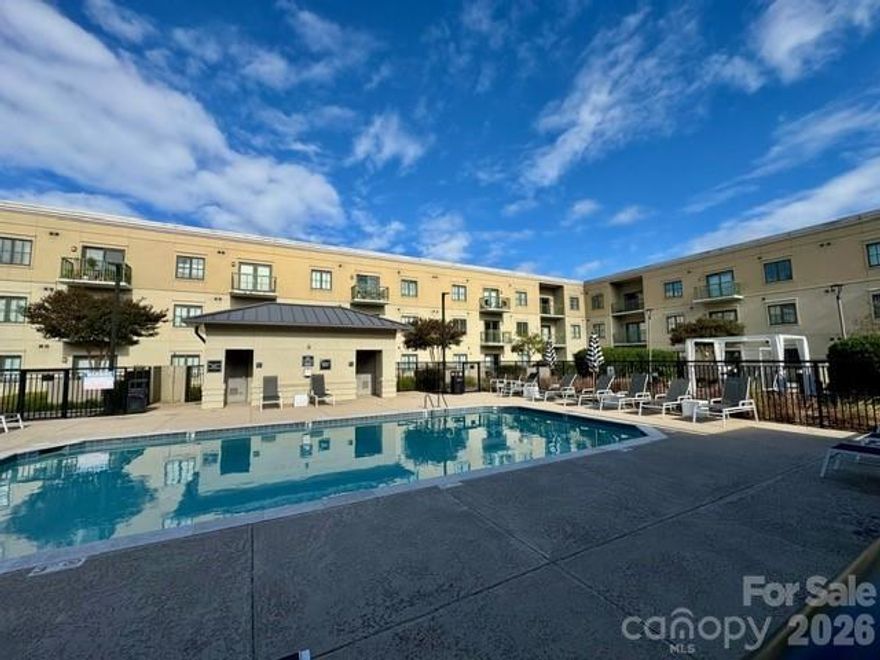 Perfectly positioned in the heart of SouthPark, this sophisticated one-story condo offers an exceptional blend of modern style and effortless city living just moments from Charlotte’s premier shopping, dining, and entertainment. Designed with a bright and open concept, the residence showcases hardwood floors, elevated finishes, and a thoughtfully designed open layout ideal for both everyday living and entertaining. The kitchen features a gas range, stainless steel appliances, stone countertops, and a breakfast bar that seamlessly connects to the main living space. The light-filled living room is anchored by a gas log fireplace and framed by double doors that open to a private balcony—an inviting retreat for morning coffee or evening unwinding.  The spacious primary suite offers a walk-in closet, direct access to a well-appointed full bath, and a discreetly tucked-away laundry area with washer & dryer for added convenience and privacy. Residents enjoy resort-style amenities including a sparkling outdoor pool, grilling terrace, fitness center, and stylish community lounge—perfect for entertaining or relaxing with neighbors. All of this in one of Charlotte’s most coveted neighborhoods, just minutes from SouthPark’s luxury retail, renowned restaurants, and vibrant lifestyle.  Includes one dedicated parking space (#17) conveniently located facing Firebirds, with additional covered parking available beneath the 721 building. Experience stylish, low-maintenance living in one of Charlotte’s most desirable neighborhoods.