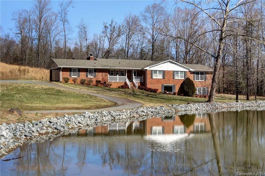 Looking for privacy 28.71 acres with beautiful stocked pond in Charlotte! Great location convenient to I-485, Uptown Charlotte, Restaurants, and Retail. Full Brick Ranch with finished basement features full bathroom, rec room & tons of storage. Unlimited possibilities Perfect for equestrian farm, farming, & family estate. Additional heated sq ft added in 2002; updates completed in 2002, new roof 2012 & well 2006. Home Warranty Included! Seller financing available! no permit for addition