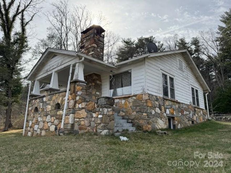 Nice  2 bedroom 1 bath 1959 house in Swannanoa that is in need of updated electrical, flooring, porch etc.  quiet setting,  nice views.  Chicken coop, one car garage.  No appliances.   Needs updating.