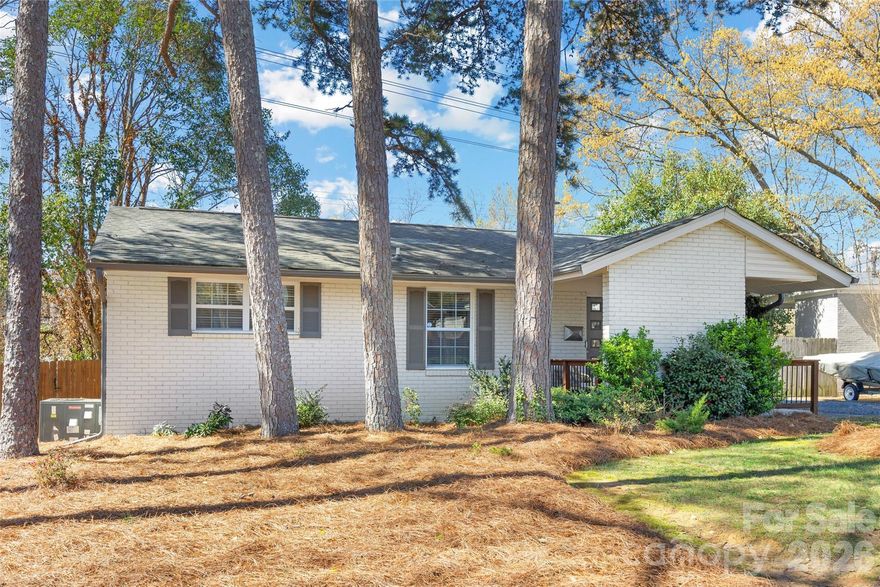 Tucked away in the sought-after Madison Park neighborhood, this mid-century painted brick ranch blends timeless character with thoughtful updates. Beautiful hardwood floors and a light, neutral palette create a warm, inviting feel throughout. The renovated kitchen features gray shaker-style cabinetry, quartz countertops, and stainless steel appliances, including a gas range. A spacious living area flows effortlessly into a designated dining space, ideal for everyday living and entertaining. The primary bedroom offers the convenience of a private half bath, while two additional bedrooms and an updated full bath complete the interior. Outside, enjoy a generous backyard with an expansive deck—perfect for relaxing or outdoor gatherings. Conveniently located just minutes from Park Road Shopping Center and LoSo, with easy access to SouthPark, Uptown, and Charlotte Douglas International Airport.