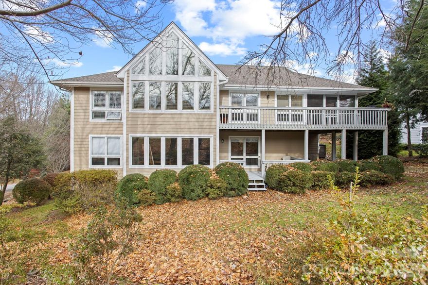 Stunning Golf Course Condo on the 16th Fairway in Prestigious Kenmure. Exceptional four-bedroom, three-bath condo ideally located on the 16th fairway in Kenmure, a highly sought-after gated golf course community. This beautifully updated residence offers an outstanding open floor plan, abundant natural light, and golf course views. Prepare to be impressed as you enter the main level featuring vaulted ceilings and a dramatic great room with a wall of windows overlooking the fairway. The great room is highlighted by a gas fireplace flanked by custom bookcases and flows seamlessly into the dining area and upscale kitchen—perfect for entertaining. The spacious kitchen is both stylish and functional, featuring granite countertops, tile backsplash, high-end stainless steel appliances, a large island with a one-piece sink and breakfast bar, and a pantry. The dining area remains open to the main living space, enhancing the home’s inviting layout. The primary suite is a true retreat, offering a large walk-in closet and a spa-like upgraded bath with double vessel sinks and a stunning tiled walk-in shower with bench and dual showerheads. A guest bedroom on the main level also functions beautifully as a den or office, along with a guest bath and a spacious laundry room with washer and dryer. The lower level features a generous family room with a wall of windows, built-in entertainment/bookcase, and sliding doors leading to the deck. Two additional guest bedrooms and a full bath complete this level, offering privacy and flexibility for guests. Outdoor living is exceptional with multiple spaces to relax and enjoy the golf course views, including a covered front porch, screened porch, and expansive multi-level decking. Convenient golf cart access to the clubhouse and amenities via a nearby cart path adds to the lifestyle appeal. Ideally located near the entry gate, amenities, and just minutes from downtown Hendersonville shopping and restaurants, this impressive condo offers luxury living, stunning views, and an unbeatable location in Kenmure.