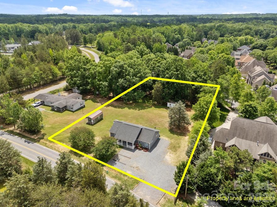 So many possibilities, live here, use as a short or long term rental opportunity, or build your dream home! This adorable ranch home was built in 2018. It is located just 5 minutes from downtown Davidson, and situated on an acre of land that is tucked between luxury homes within the communities of River Run and Davidson Farms. The 3brd/2ba split floorplan grants privacy to the primary suite which has his and her closets. High ceilings make the open concept floor plan feel spacious. It has a beautiful level backyard and mature landscaping. Located just a mile from the planned Summit Farms development, a 62 acre farm to table village which will include a 10 acre organic farm, farmer's market, pizza, deli, bakery, and of course coffee! There will also be multiple outdoor gathering spots and children's play areas. The adjacent property at 14536 E Rocky River Rd recently sold with plans for a new build through Classica Homes. The new water meter tap fee has been paid to Charlotte Water. A recent septic improvement permit was issued for a new 5 bedroom home. Or, there is room to add-on bedrooms to the existing system. Natural gas is available at the road. No HOA!!