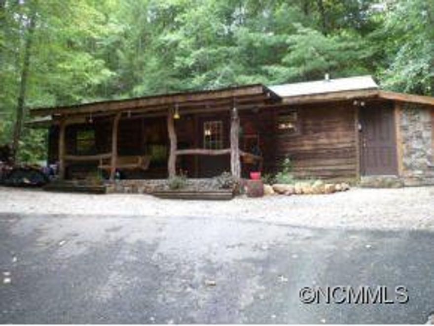 Rustic Cain in the woods! Two Bedroom 1 bath with wood burning fireplace remodeled last year with all new kitchen hickory cabinets, granite countertops, stainless steel appliances, paint, laminate/tile flooring, granite counter in bathroom, new lights fixtures, ceiling fans and lots of landscaping! Has central hear/air, DLS, garden space and all paved access. Private setting was a successful vacation rental prior to the remodel. Priced to sell!