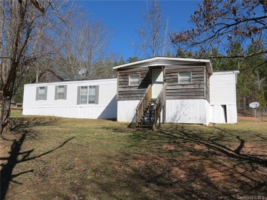 Private home with fenced pastures and over 4 acres of land.  This home has 2 bedrooms and 2 full baths with a large open living area and kitchen in the center of the home.  There is a large covered back porch for enjoying the wildlife and privacy.  There is a large storage/workshop building behind the home.  The property has a storm shelter just outside the back door and plenty of room to roam.